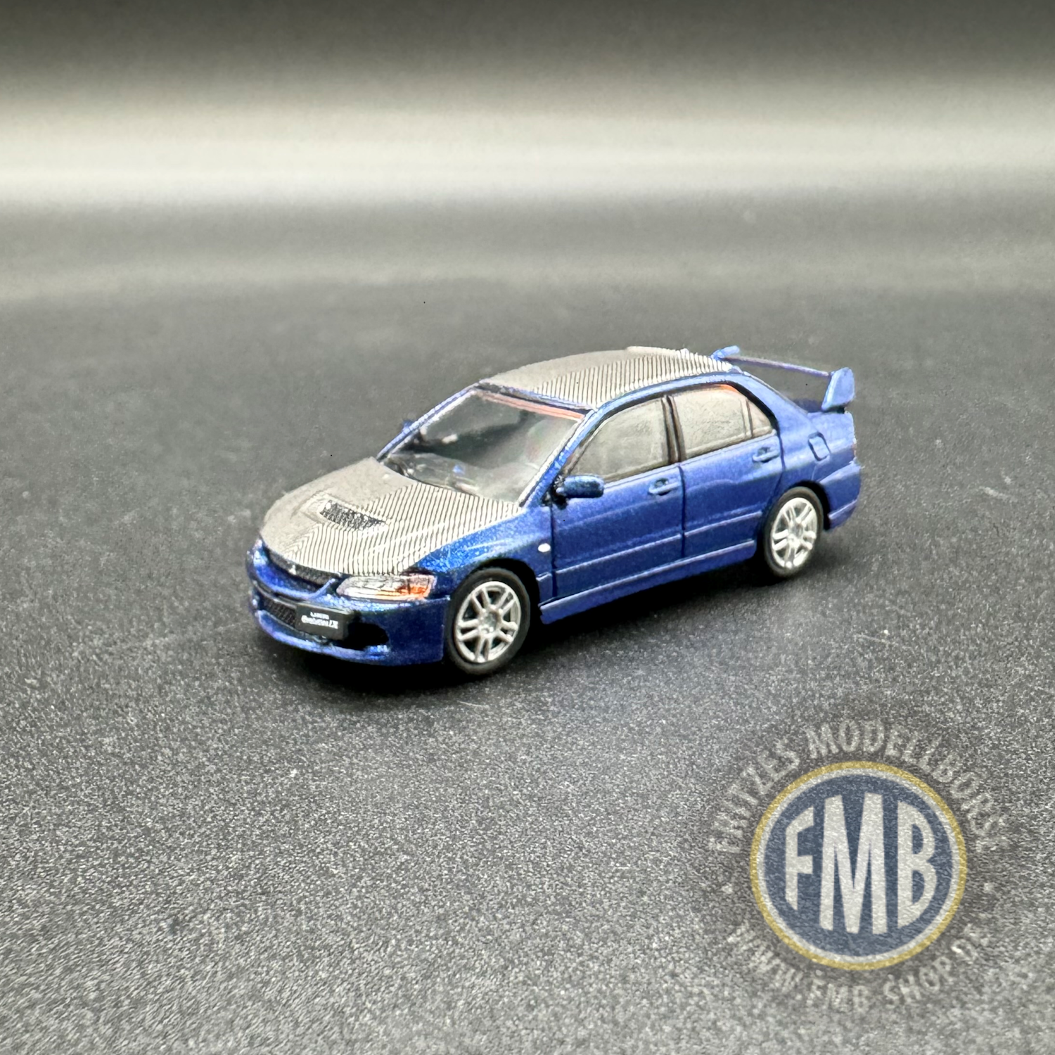 64116 - Micro City 87 - Mitsubishi Lancer Evo9, blau metallic - Carbon