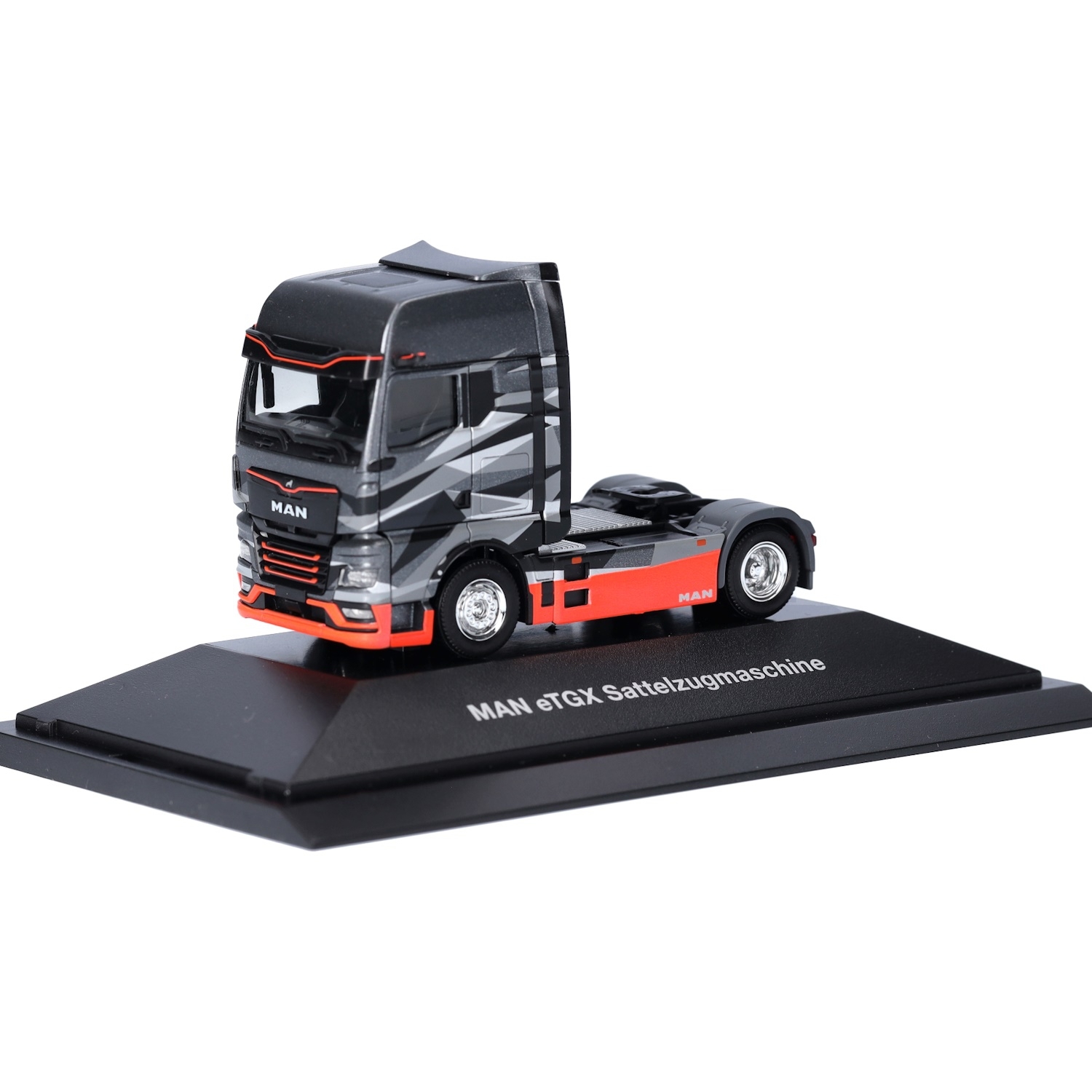 953719 - Herpa - MAN eTGX GX electric truck tractor with OptiView, gray/orange - PC