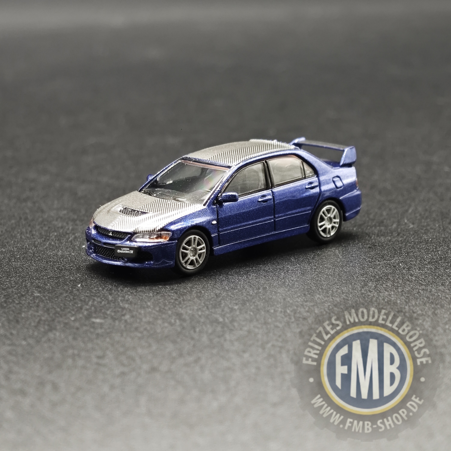 64116 - Micro City 87 - Mitsubishi Lancer Evo9, blau metallic - Carbon